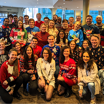 All smiles as FundApps end 2021 with SEP as a business partner. FundApps employees in Christmas jumpers smiling at the camera. 