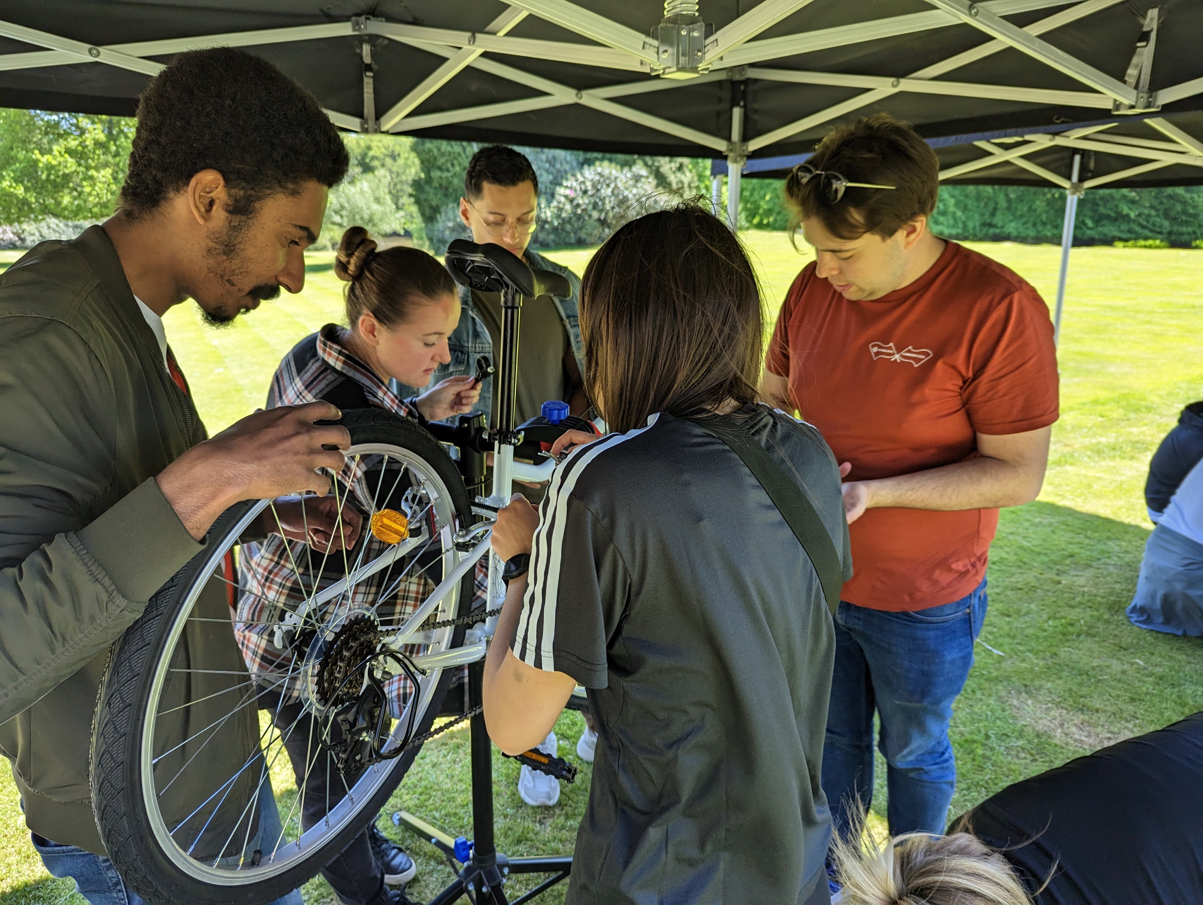 FundApps team working together to build a bike. Join the ride with FundApps and re-cycle. We are a B-Corp having a positive impact for the planet.