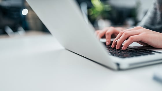 FundApps offer courses in regulatory compliance and SEC changes. Stay in control of your monitoring and reporting. Hands on a silver laptop typing.