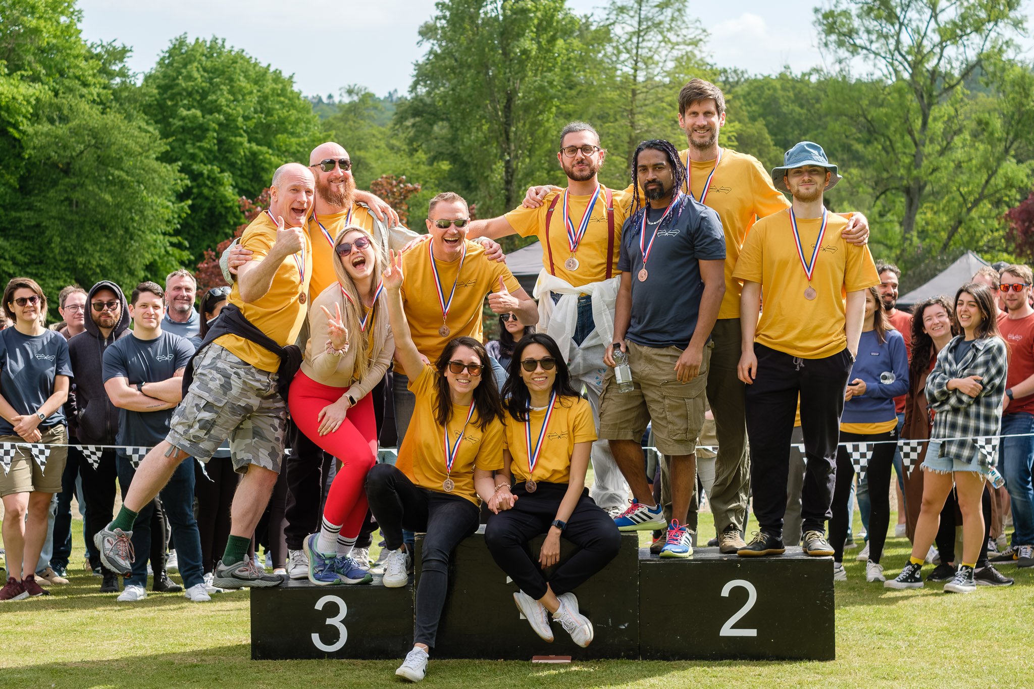 FundApps team smiling together on a podium. FundApps work together and win together to enable compliance teams to respond to regulatory change. 