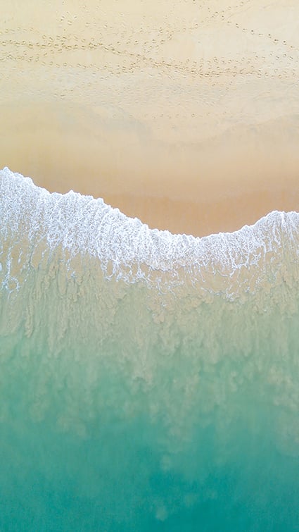 Blue waves on a sandy beach. Relax with FundApps, as we help investment management firms to find solutions to make disclosure processes seamless. 